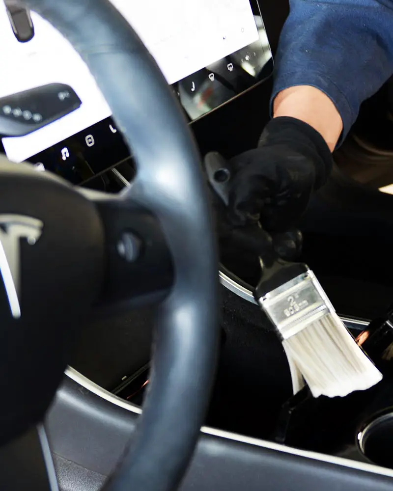 Interior auto detailing and careful cleaning of a vehicle cabin