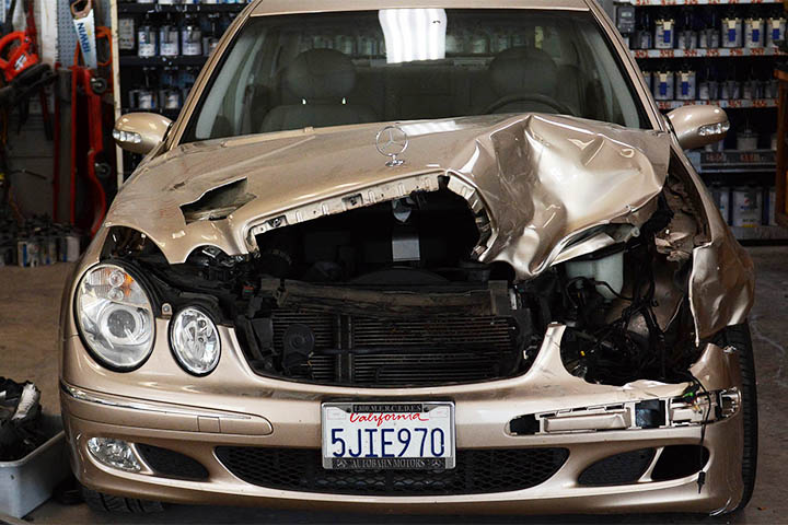 Front-end collision damage on a Mercedes-Benz before auto body repair